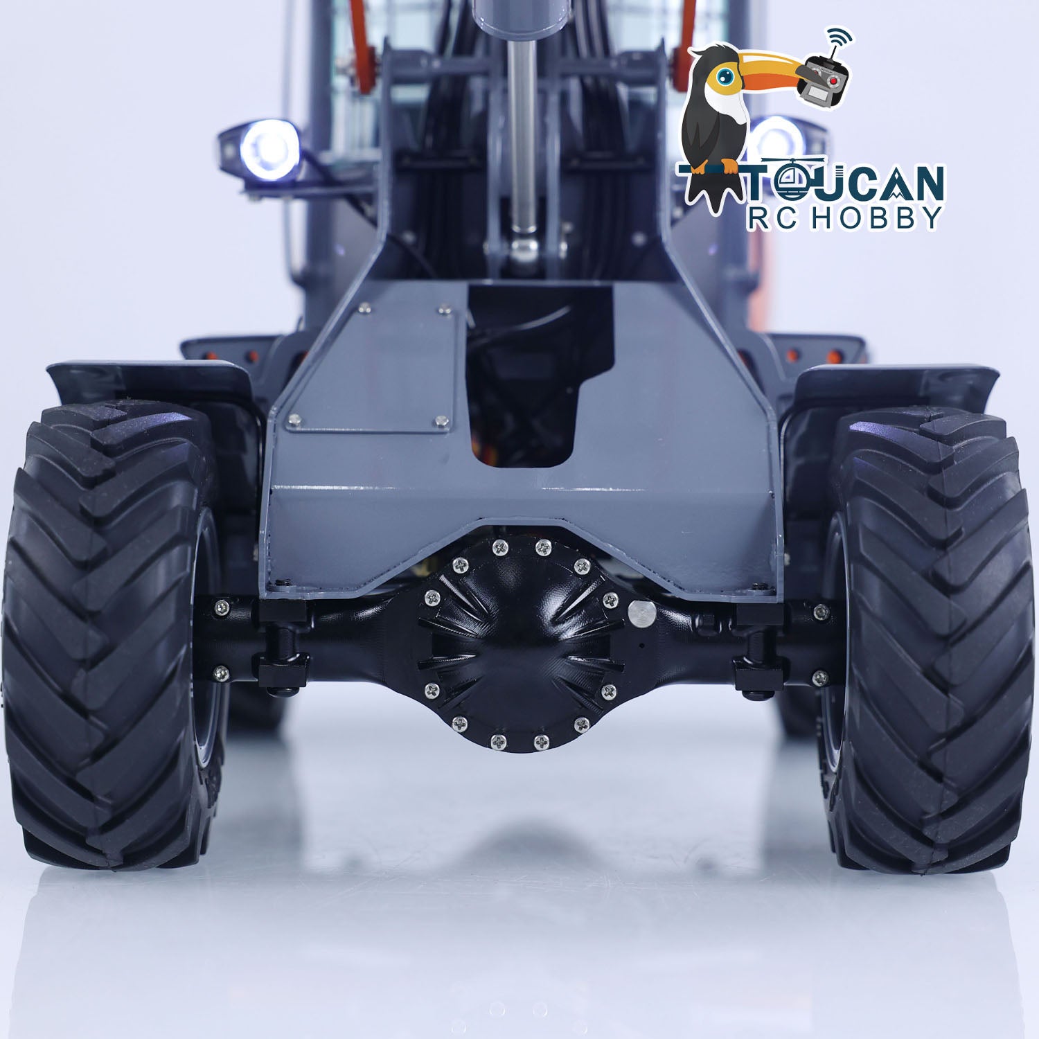 Rear view of RC MCL8 wheel loader, showing rear axle, differential and large off-road tires
