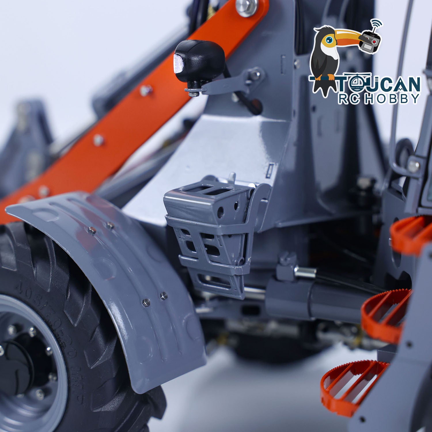 Chassis and wheel well detail of LESU MCL8 RC loader, showing suspension, hydraulic lines and metal frame

