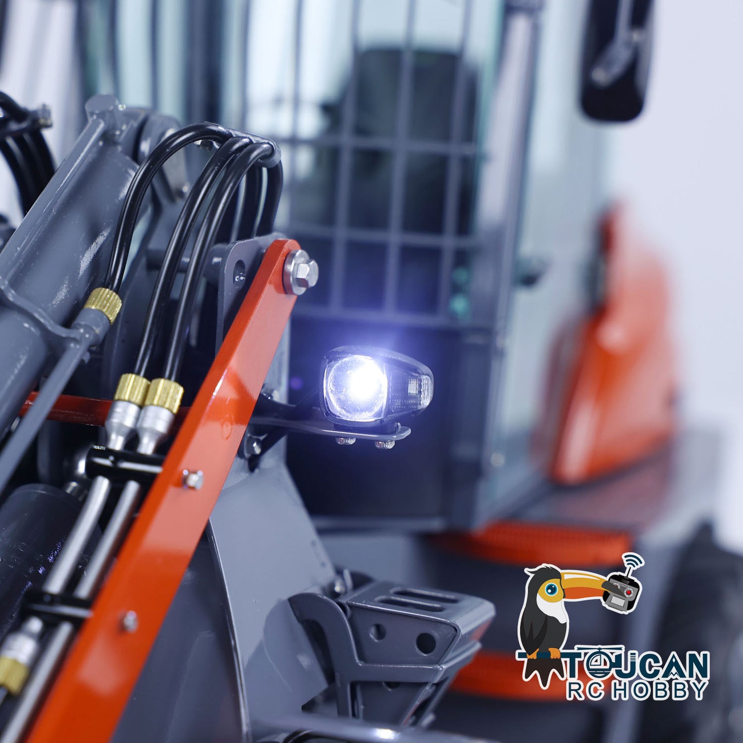 LED front light on RC MCL8 loader, with illuminated working light and detailed hydraulic arm assembly
