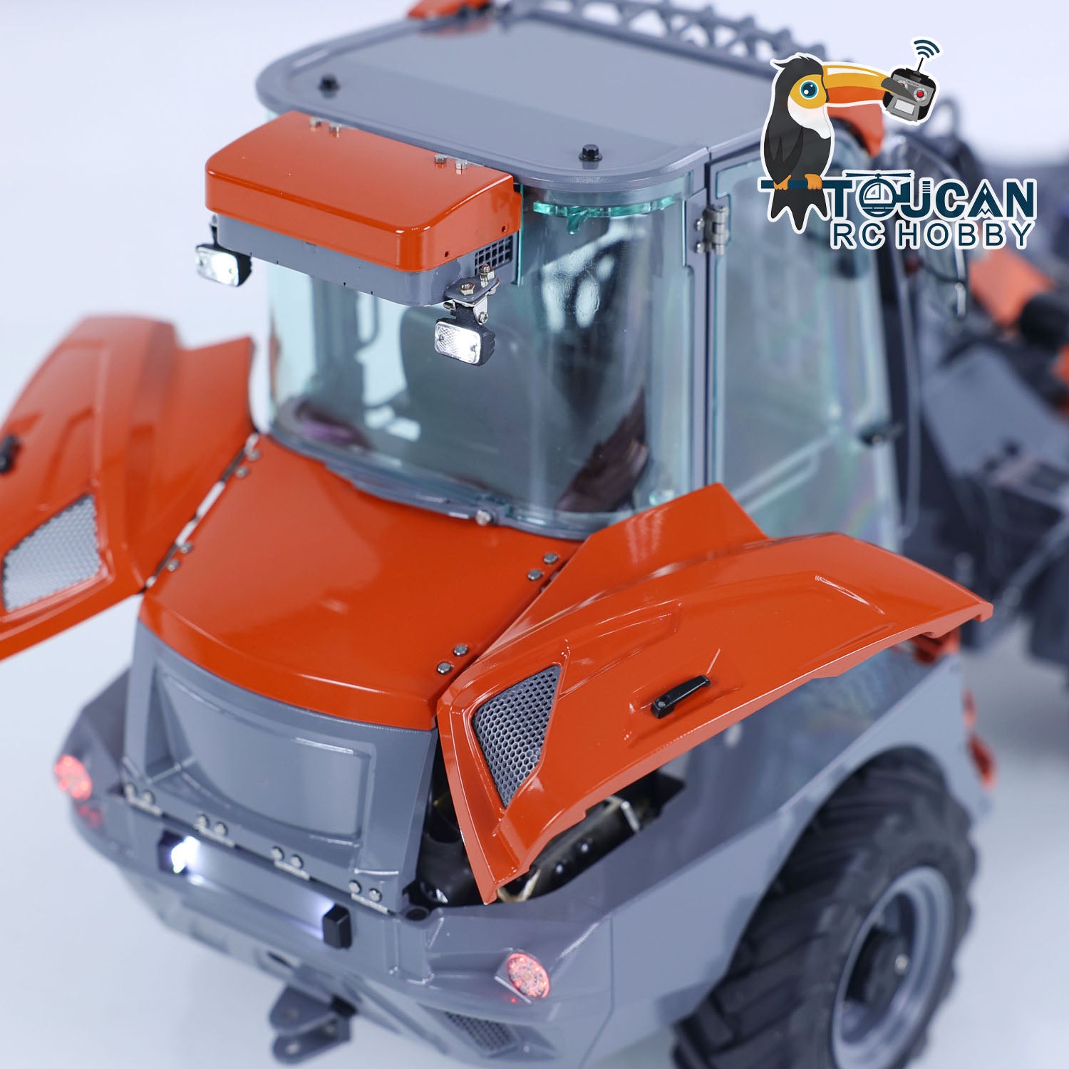 Front cabin view of LESU MCL8 wheel loader, orange and gray painted body with detailed cab windows and front lights
